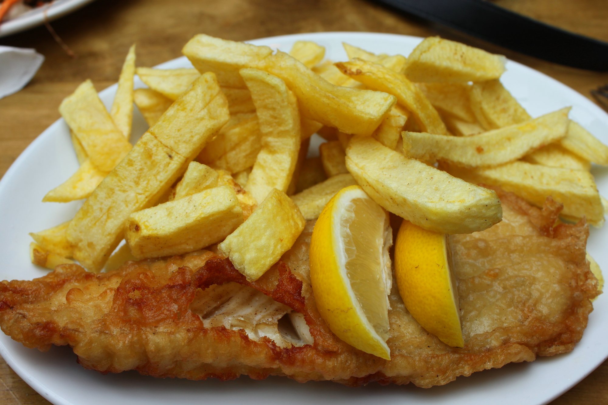 Golden battered cod with chunky chips and a slice of lemon